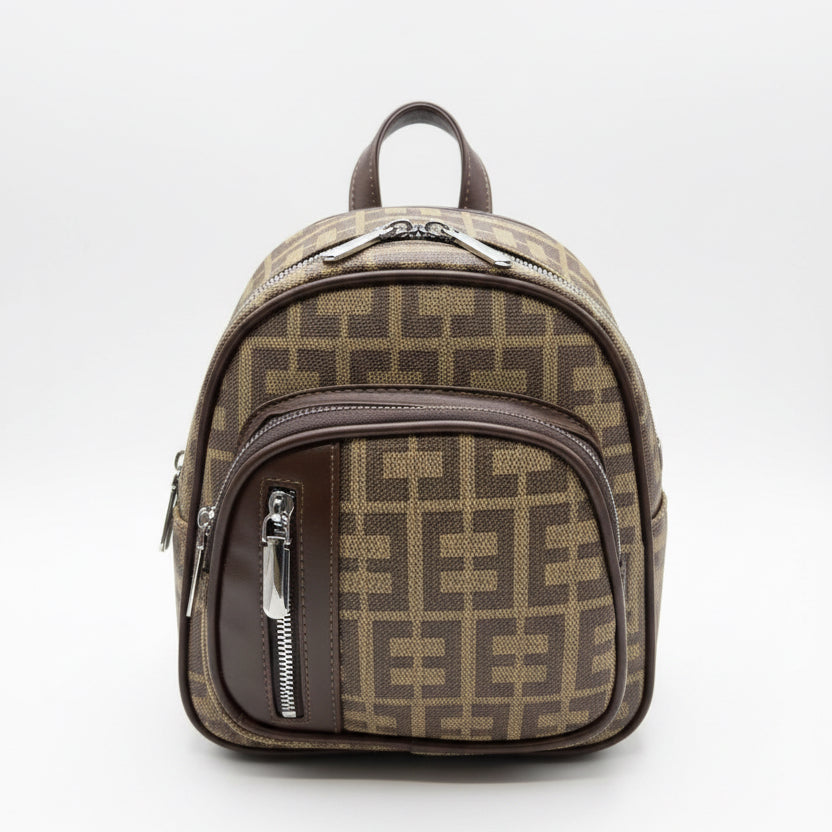 Hand holding a patterned bag in a store setting with various items in the background