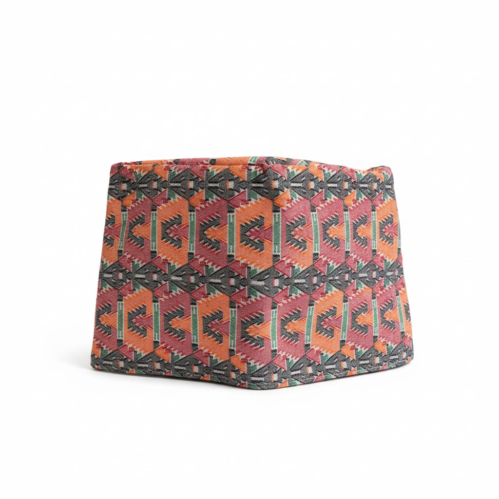 Patterned dhaka topi on a white background