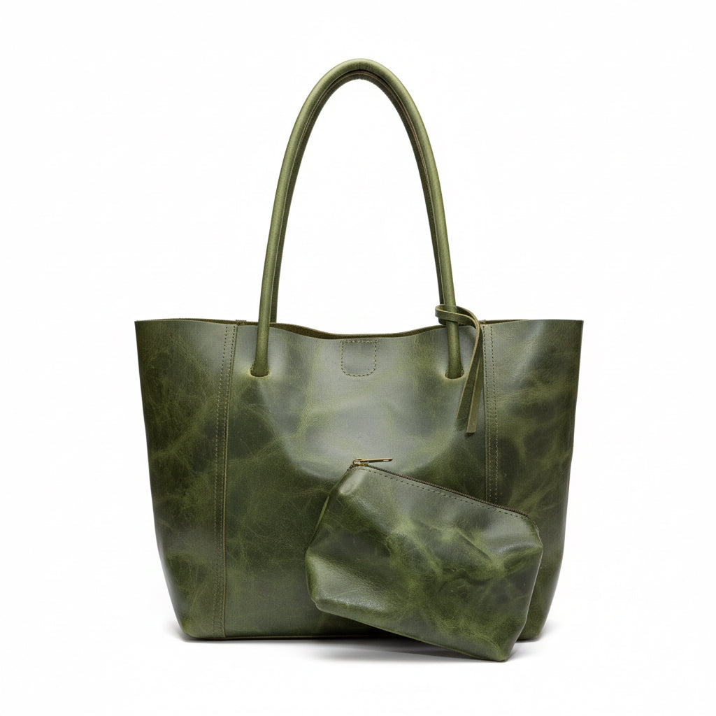 Green marble-patterned handbag and pouch on a wooden surface next to a laptop.