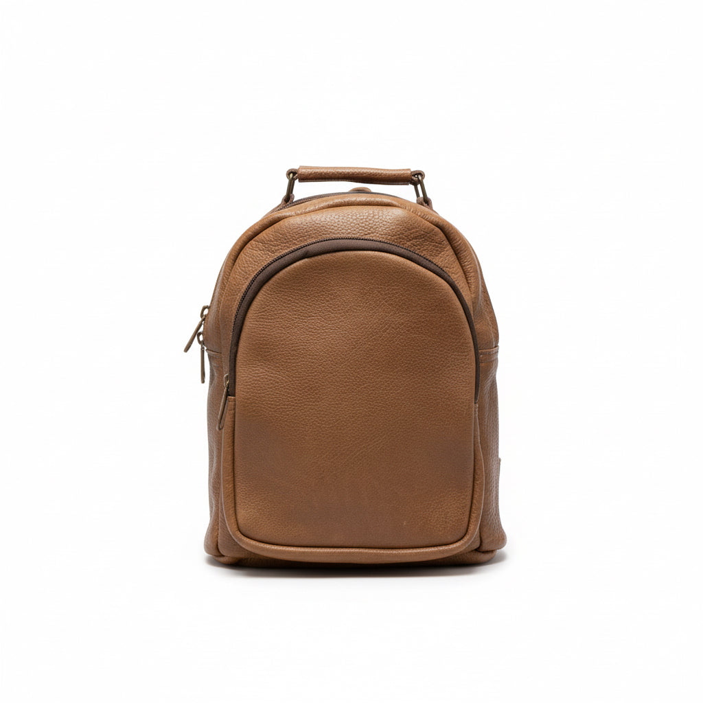 Brown backpack on a wooden surface with a blurred background