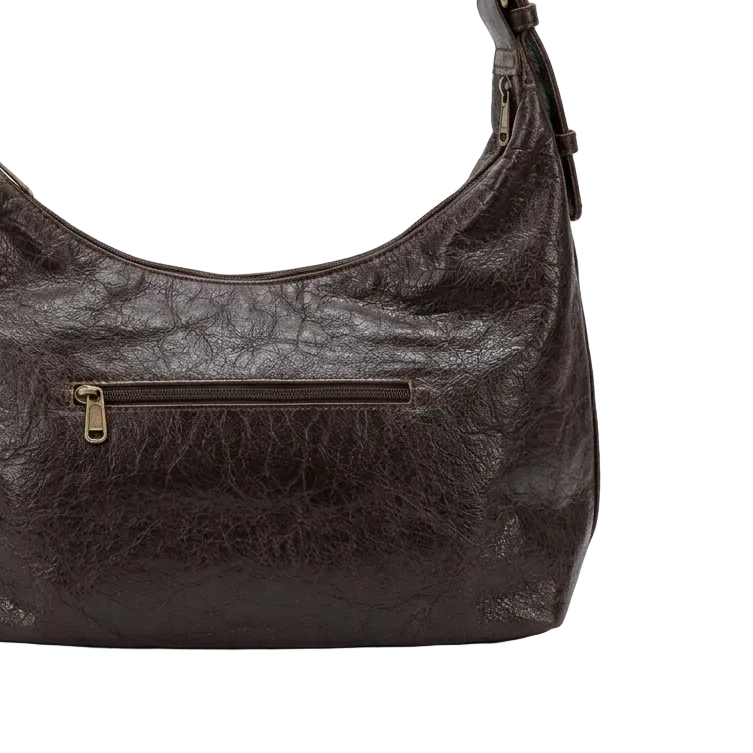 Brown leather handbag with gold zipper on a white background