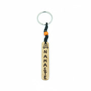 Vertical white yak bone bar keychain with Namaste carving and cream beads.