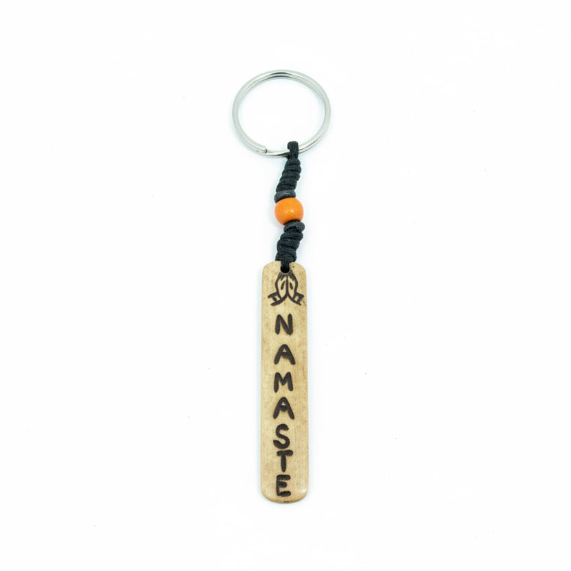 Vertical white yak bone bar keychain with Namaste carving and cream beads.