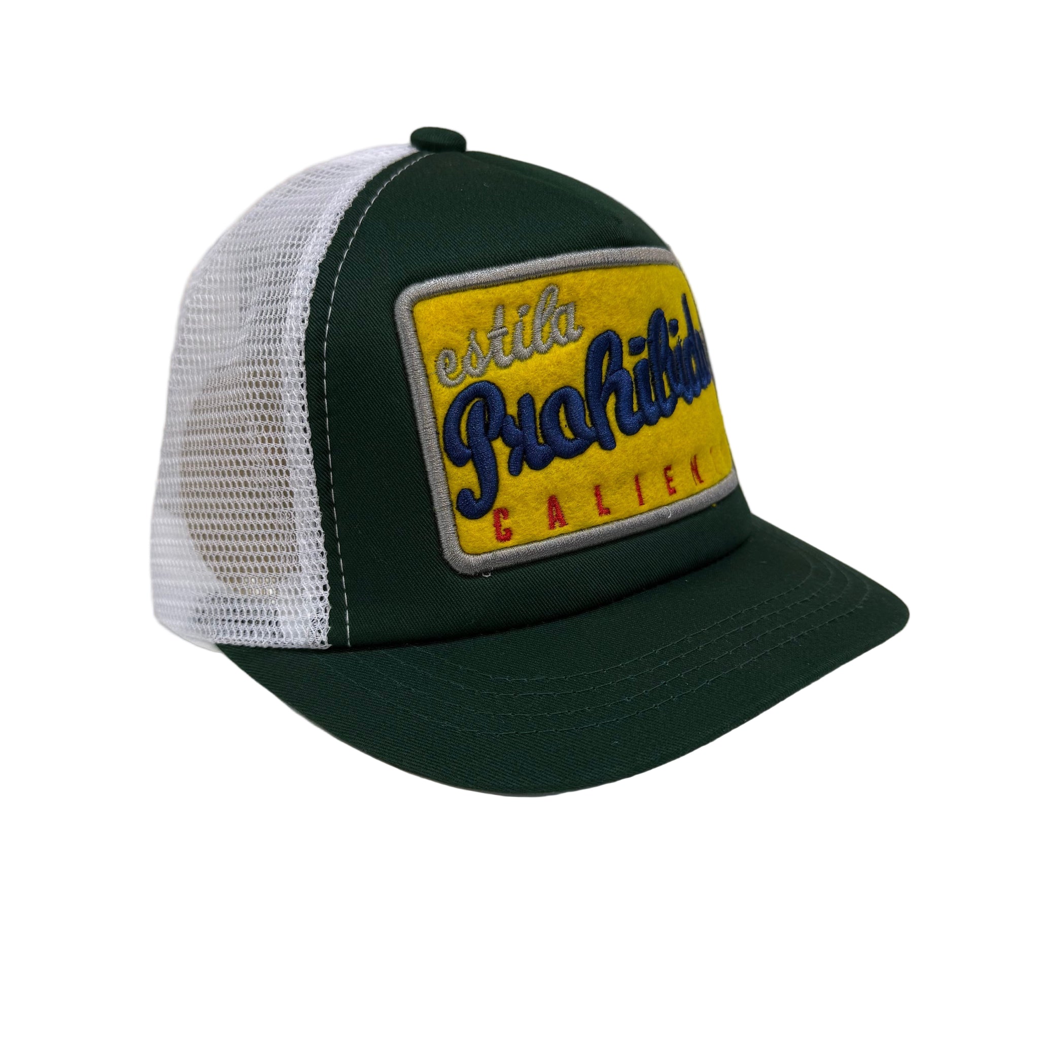 Green and white cap with a yellow patch on a white surface