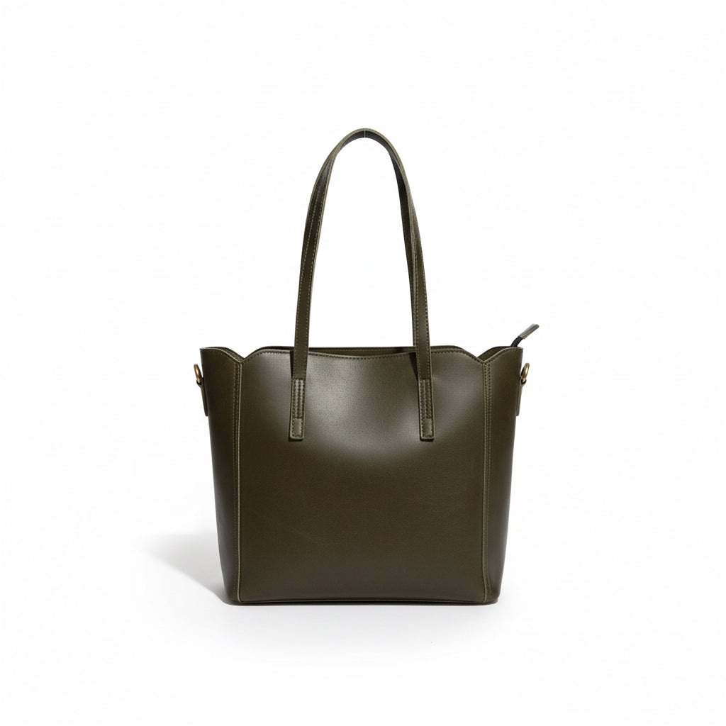 Brown leather handbag on a wooden surface with a white wall background