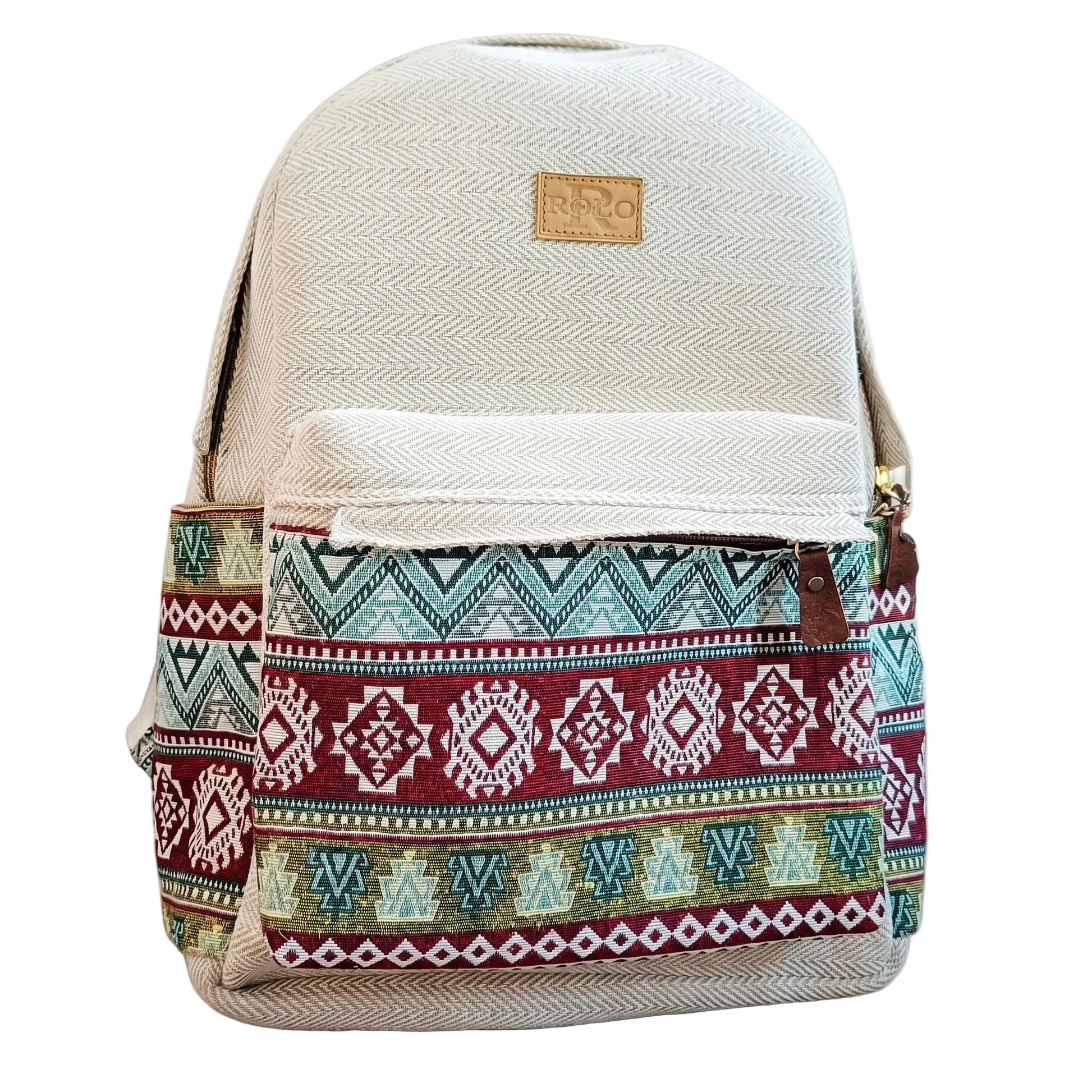 Front view of a ROLO backpack with a cream herringbone base and a vibrant multi-colored tribal geometric print on the front pocket and sides, featuring a brown leather-style logo patch on a plain white background.
