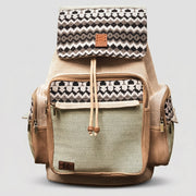 ROLO bohemian style backpack featuring a distinct black and white geometric pattern on the top flap, a light green textured body, tan suede accents, and a front pocket on a white background.