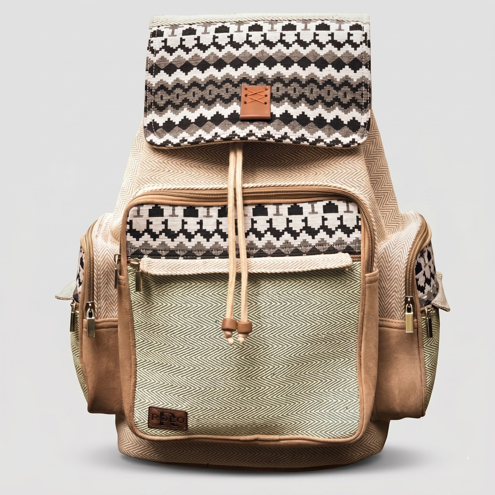 ROLO bohemian style backpack featuring a distinct black and white geometric pattern on the top flap, a light green textured body, tan suede accents, and a front pocket on a white background.