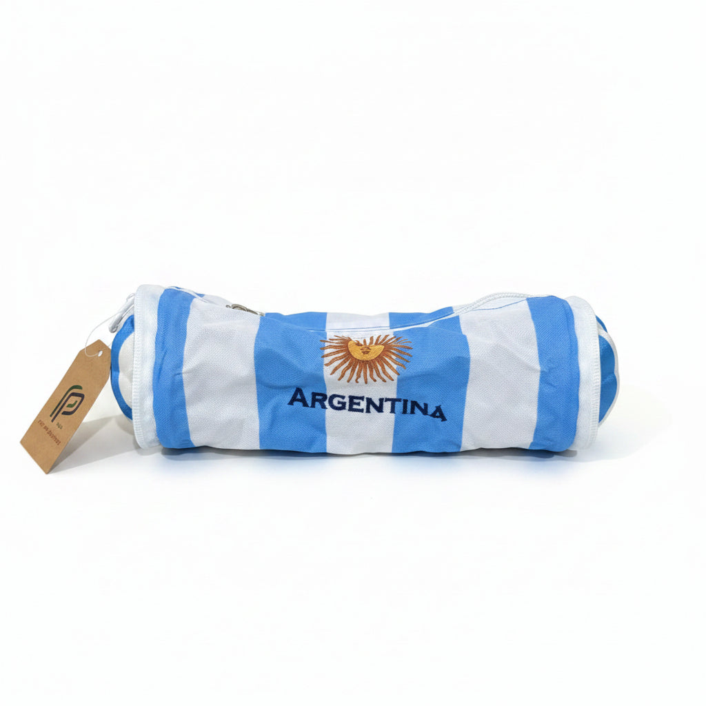 view of the striped cylindrical pencil case showing the sun emblem and embroidered text reading Argentina with a product tag.