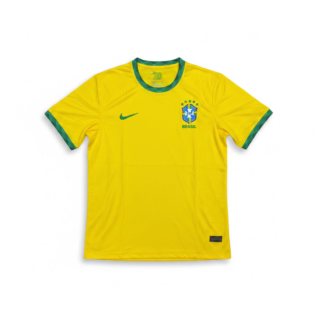 Brazil yellow soccer jersey with green trim on the collar and short sleeves laid flat against a white background