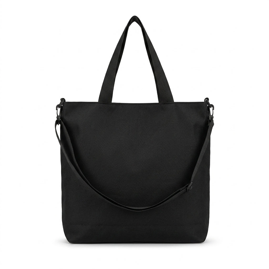 Black canvas tote bag back view showing top handles and long detachable shoulder strap