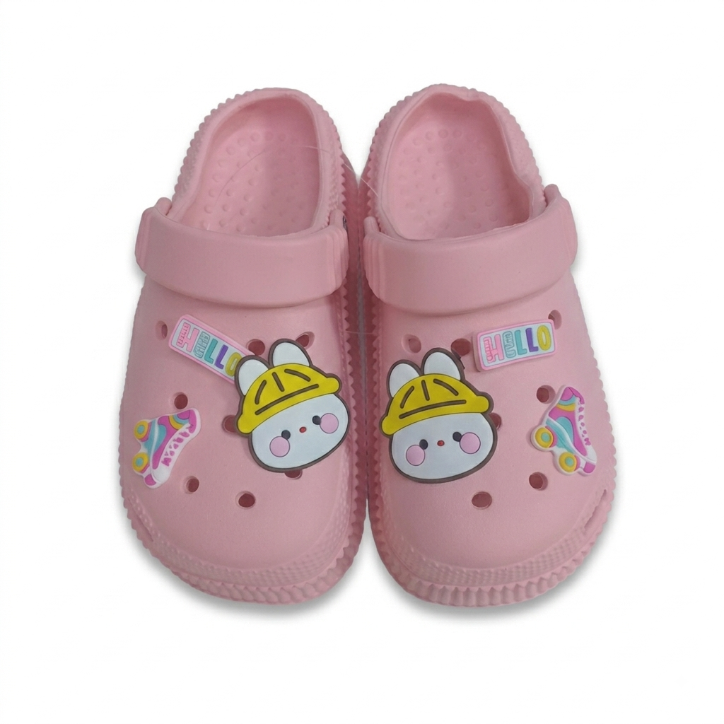 A pair of pink children's clogs with cute cartoon bunny charms wearing yellow hard hats and colorful roller skate decorations, shown on a plain white background.