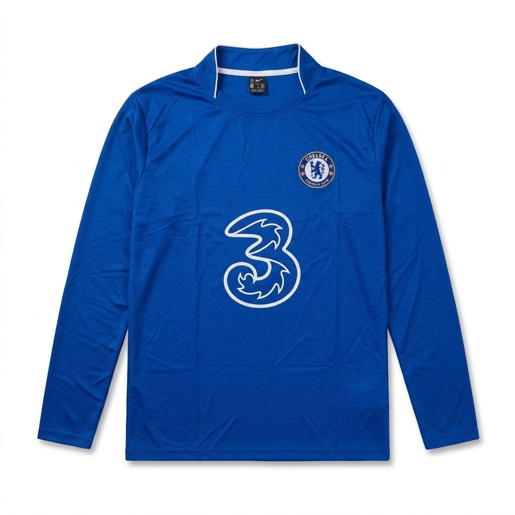 A royal blue long-sleeve Chelsea football jersey with a white outline of the 3 logo on the front and the Chelsea club crest on the left chest, displayed against a plain white background.