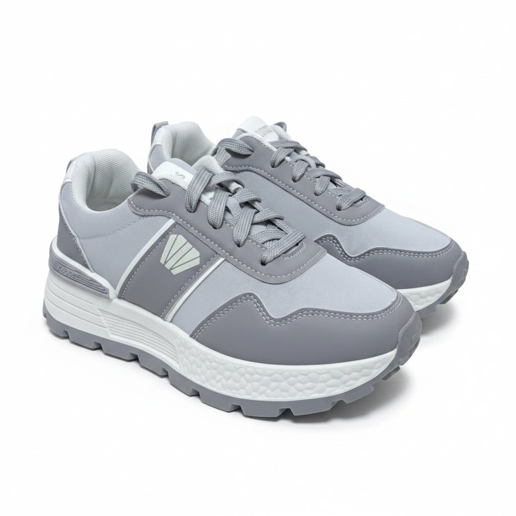 Pair of unisex grey sporty casual sneakers with a textured white midsole and dark grey tread.