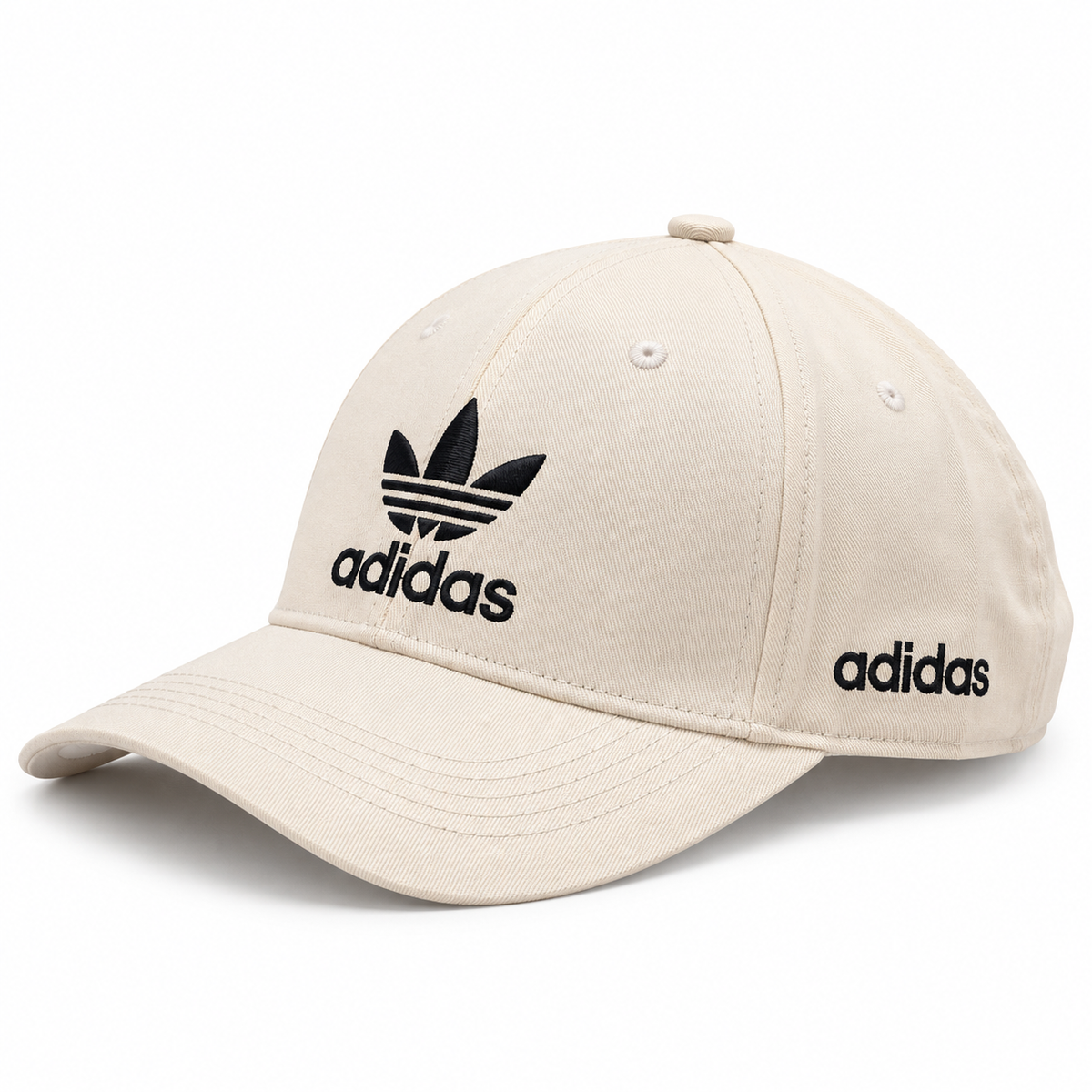 Cream baseball cap with black embroidered logo-style graphic and curved brim