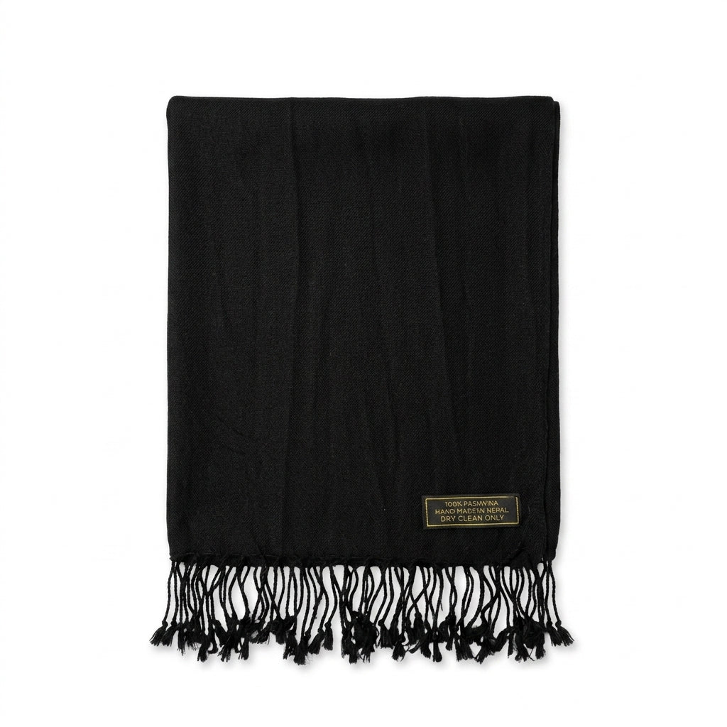 A black woven scarf with fringe detailing and a small gold brand label, displayed flat against a solid white background.