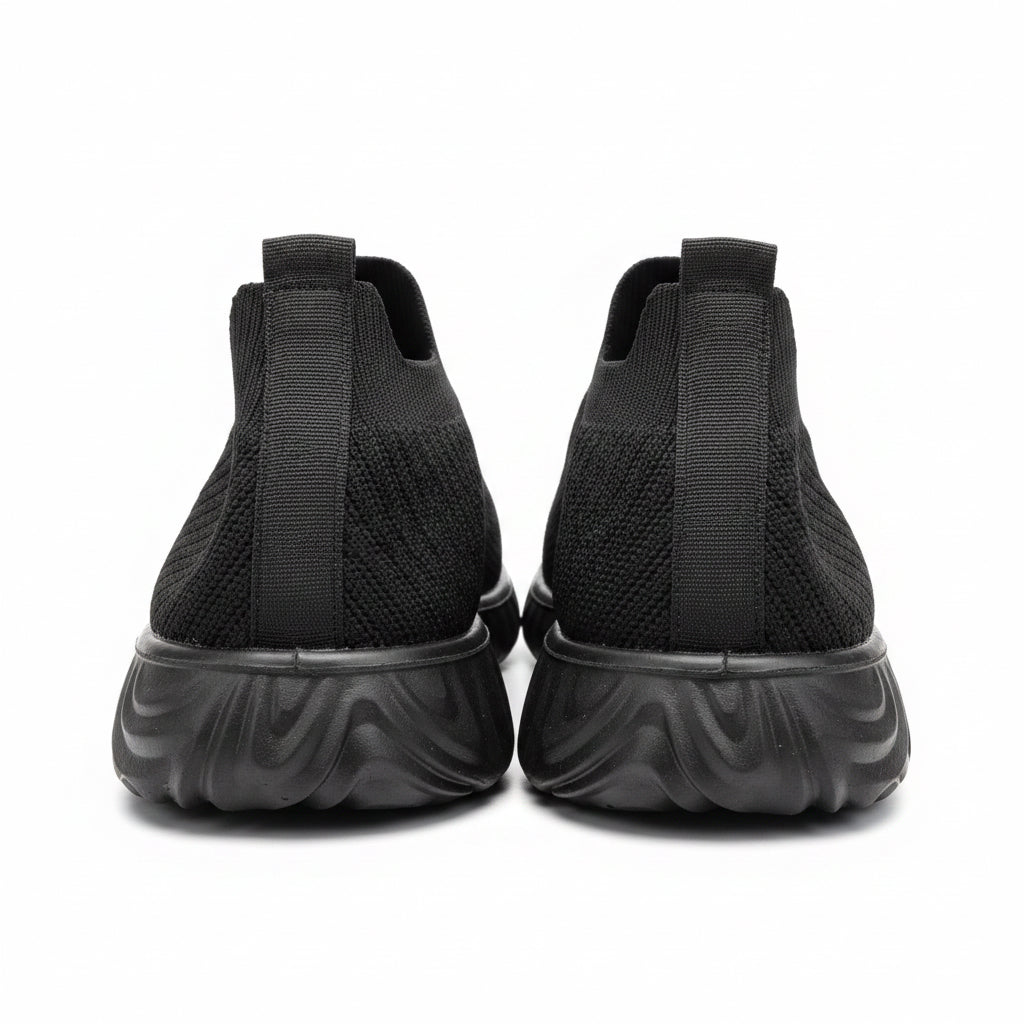 Black shoes on a motorcycle with a blurred background