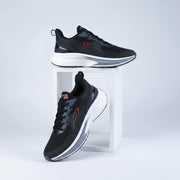 Black running shoes with dark grey textured lines, subtle red accents, a dark heel counter, and a thick white and grey cushioned sole.