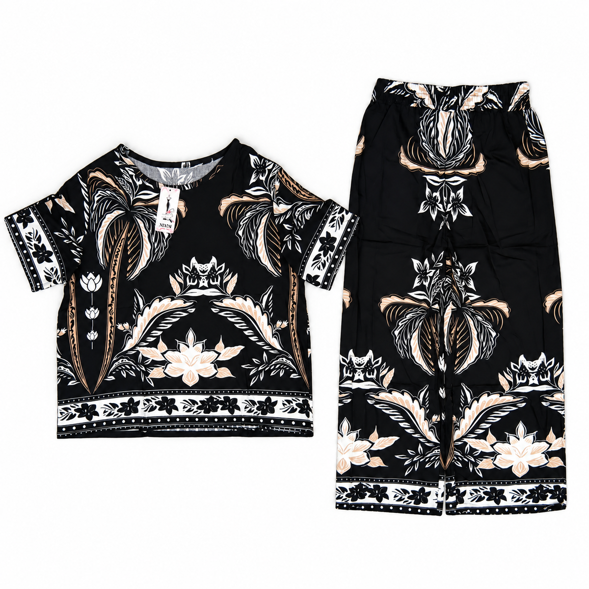 A two-piece children's outfit set featuring a short-sleeve top and matching wide-leg pants, both in black with a detailed floral and botanical pattern in beige, white, and brown, displayed on a clean white background.