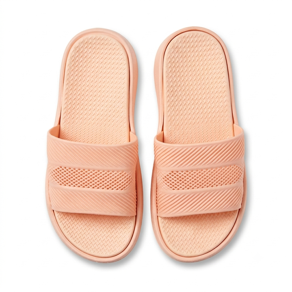 A pair of pink-colored slide sandals with textured straps and footbeds, shown from a top-down view on a white background.