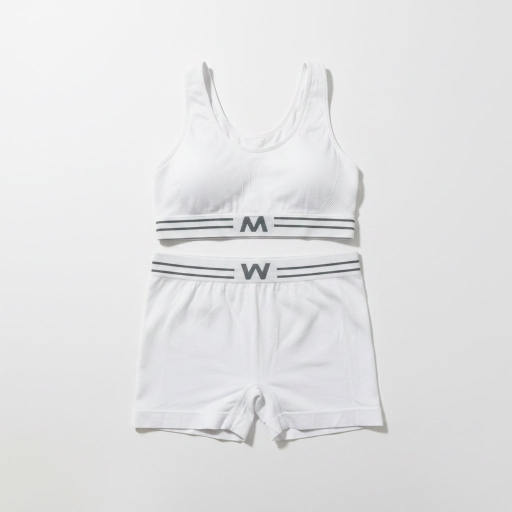 White tank top and shorts set with black lettering on a light gray background