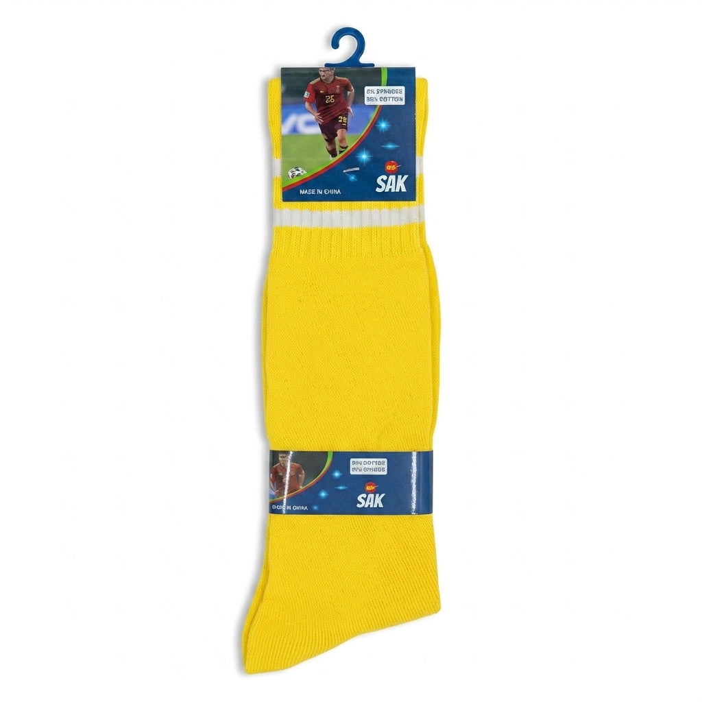 A pair of bright yellow athletic crew socks hanging from a blue plastic hanger. The socks feature a white stripe near the top and navy blue bands near the cuff with the brand name 'SAK' and a small soccer player graphic.