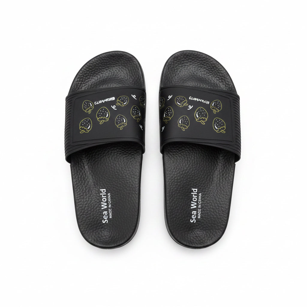 Top view of black Sea World slides with yellow strawberry outlines and textured soles.
