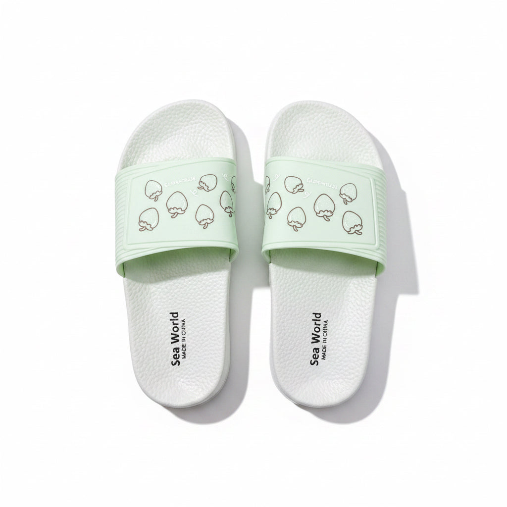 Light mint green open-toe slides with strawberry design and "Sea World" branding.