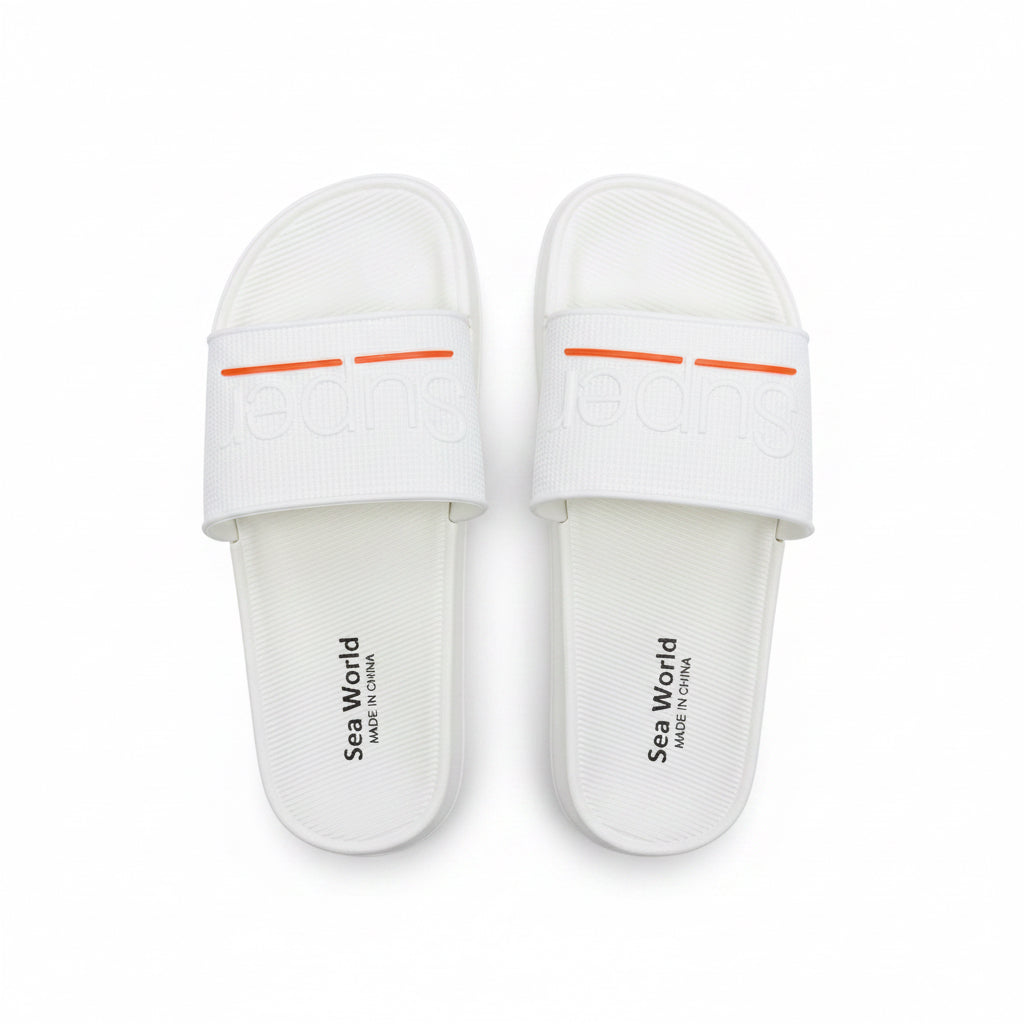 Top-down view of a pair of unisex white slide sandals with a subtle orange accent line across the upper strap.