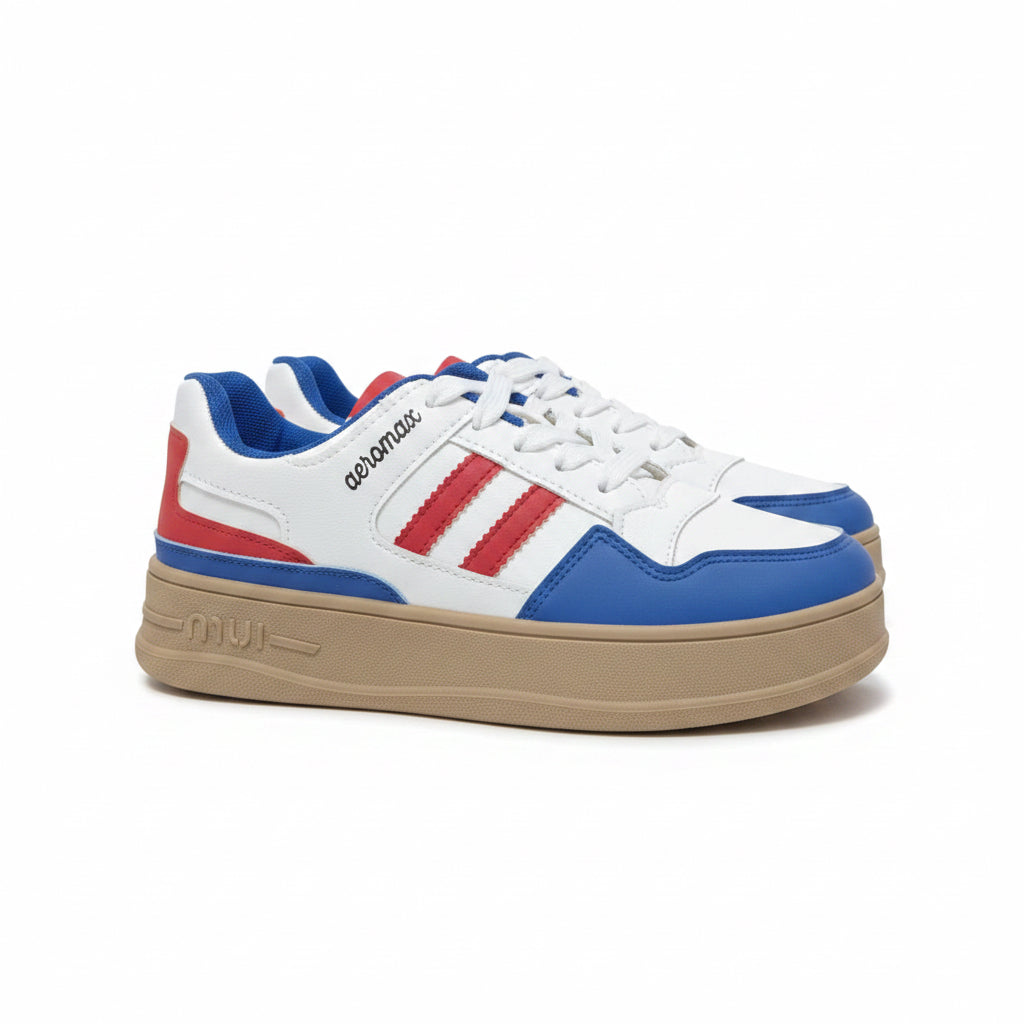 Side view of women's white chunky platform sneakers with blue panels, red stripes, and a tan sole.