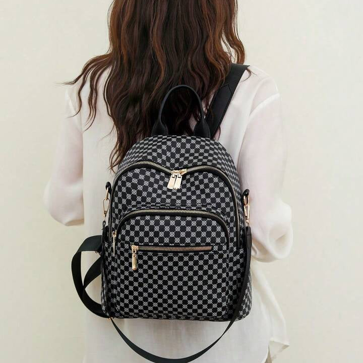 Person wearing a black and white checkered backpack against a plain background