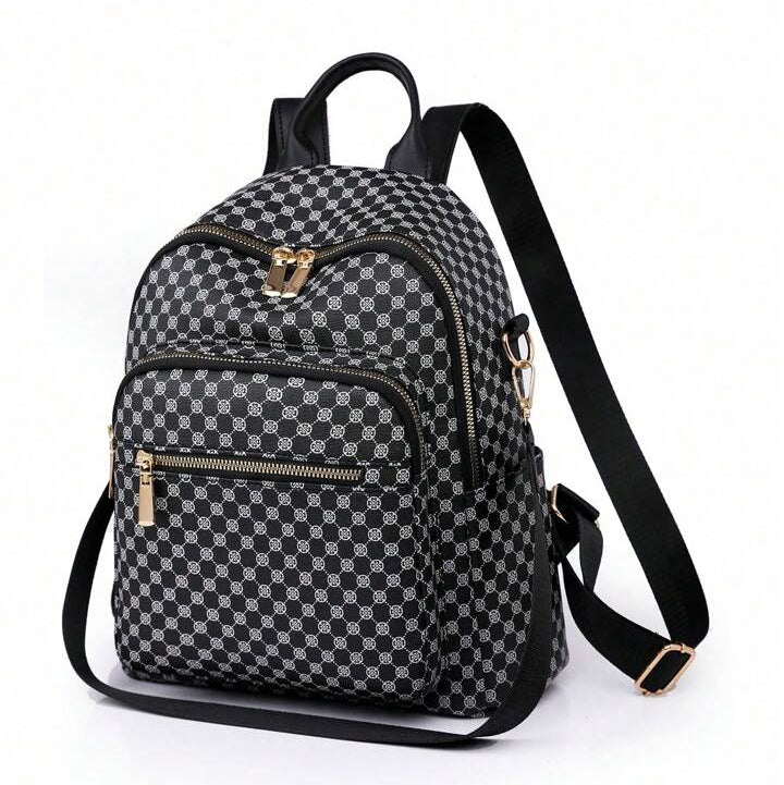Womens black casual backpack featuring an all over geometric print pattern with gold tone zippers and adjustable straps