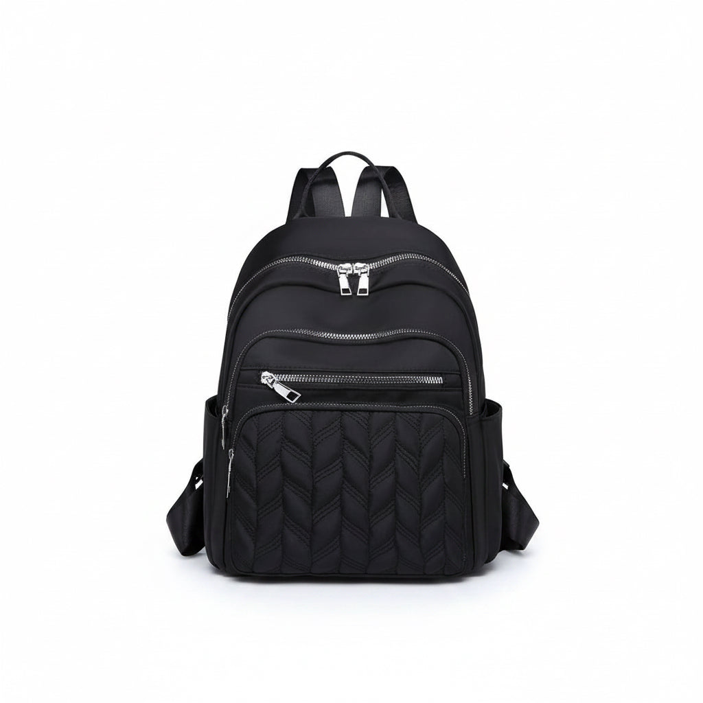 Womens black casual backpack featuring a quilted front panel design and silver zipper pockets against a white background