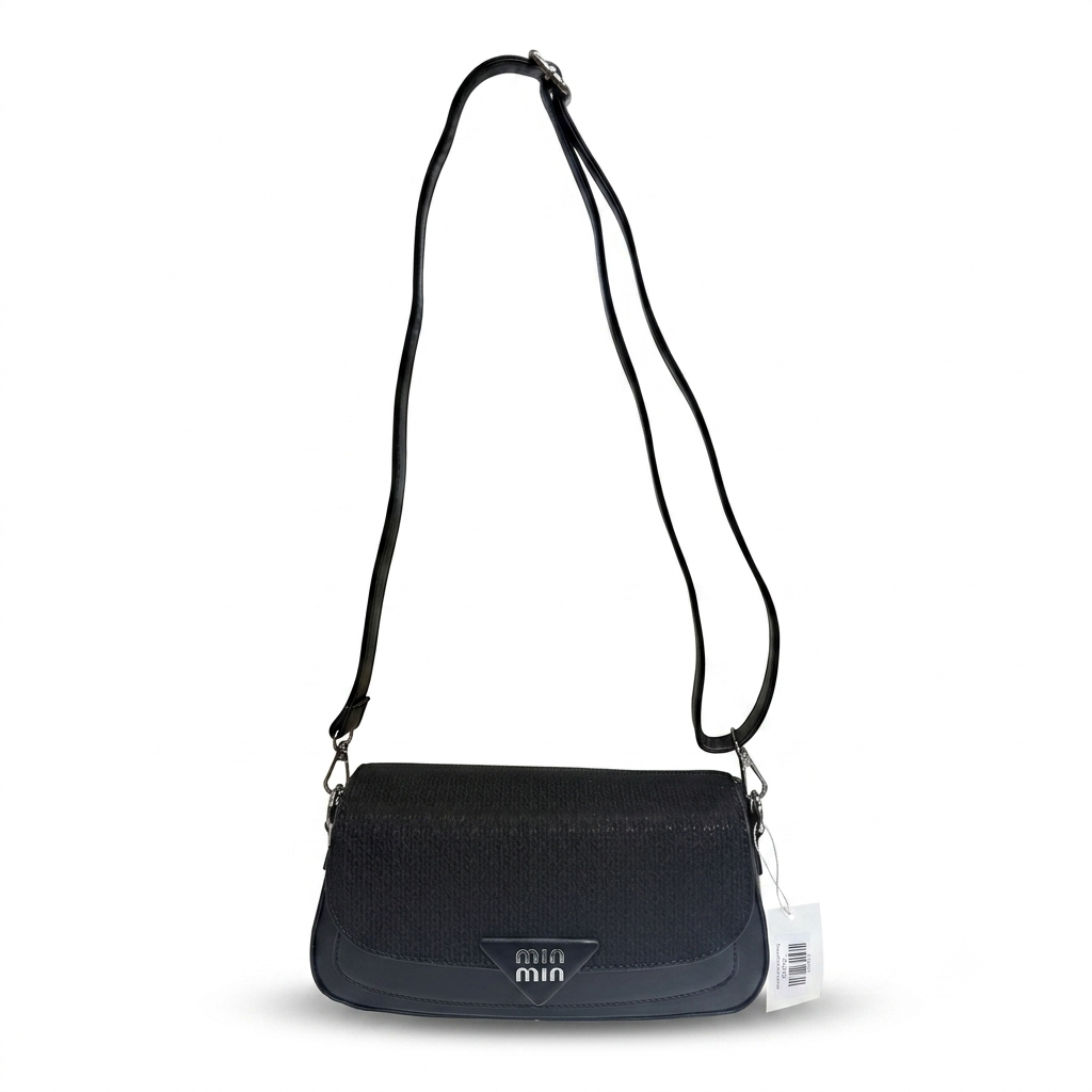 A black textured mini shoulder bag with a matching black adjustable shoulder strap and a small white hangtag, shown against a plain white background.