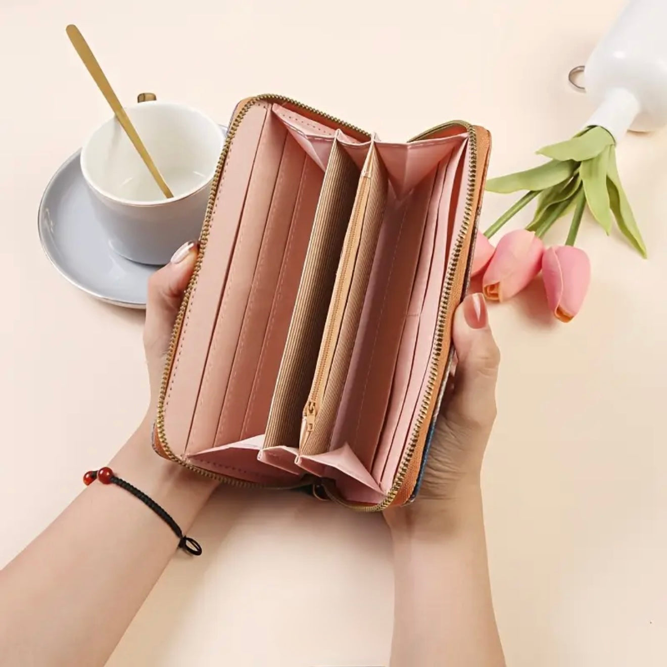 Interior view of open zip wallet showing pink card slots, accordion pockets, and zippered coin compartment