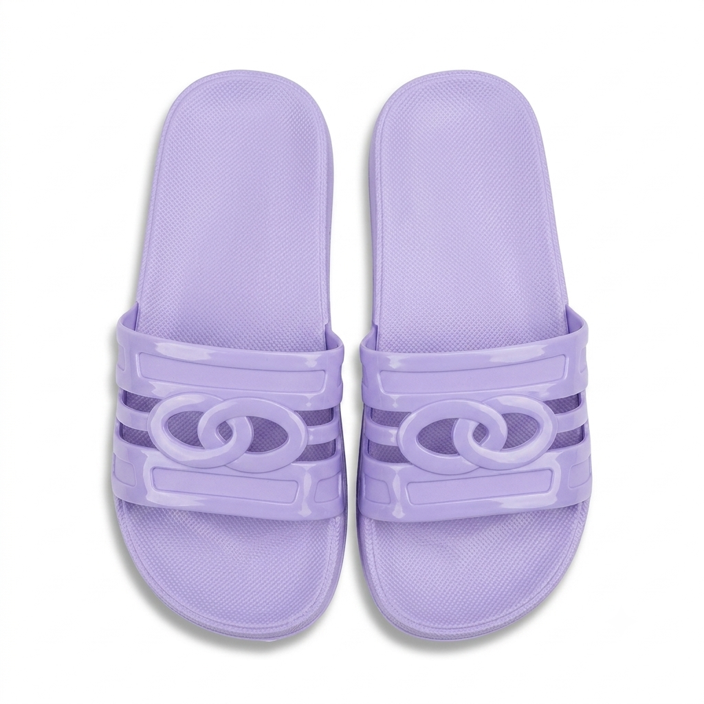 A pair of lavender purple slide sandals with a glossy interlocking double-C logo on the straps, set against a plain white background.
