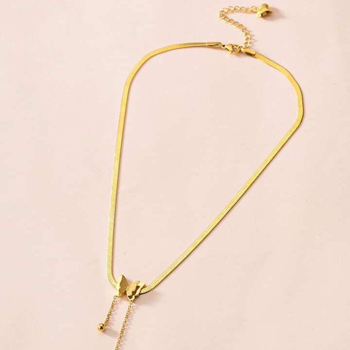 Gold necklace on a beige background
