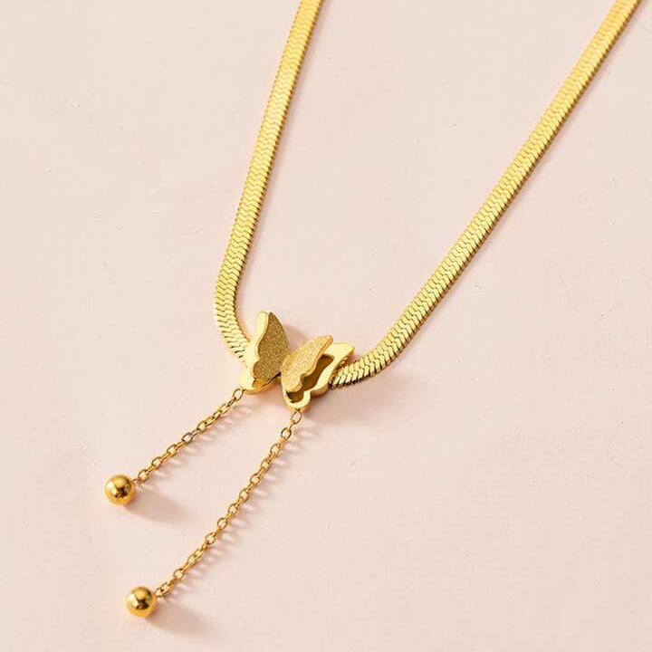 Womens gold butterfly pendant necklace with a herringbone chain design