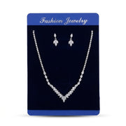 Women's silver-tone V-shape marquise crystal necklace and matching drop earrings set on blue display card