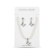 Women's faux pearl strand necklace and pavé crystal butterfly drop earrings set on card