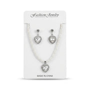 Women's faux pearl strand necklace and heart-shaped crystal drop earrings set on display card