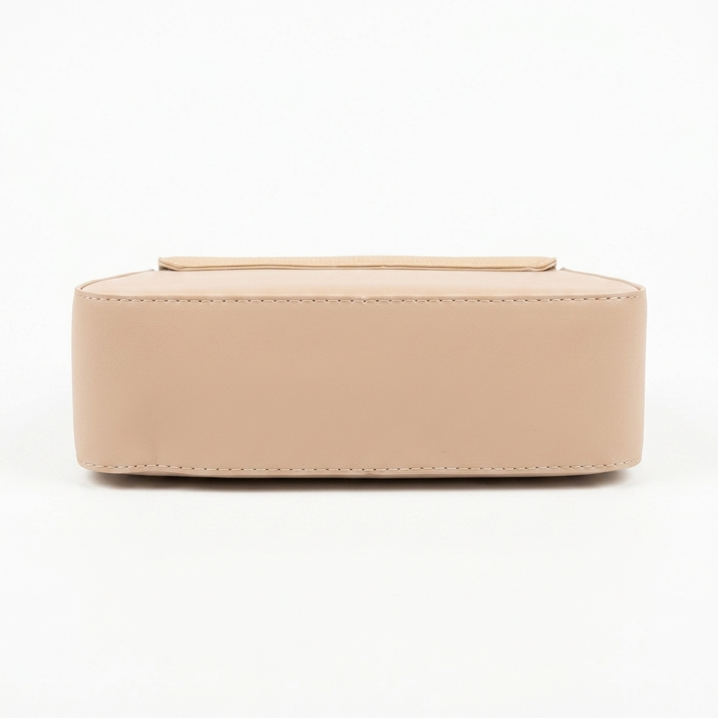 Bottom view of a structured women's shoulder bag in beige color over a white background