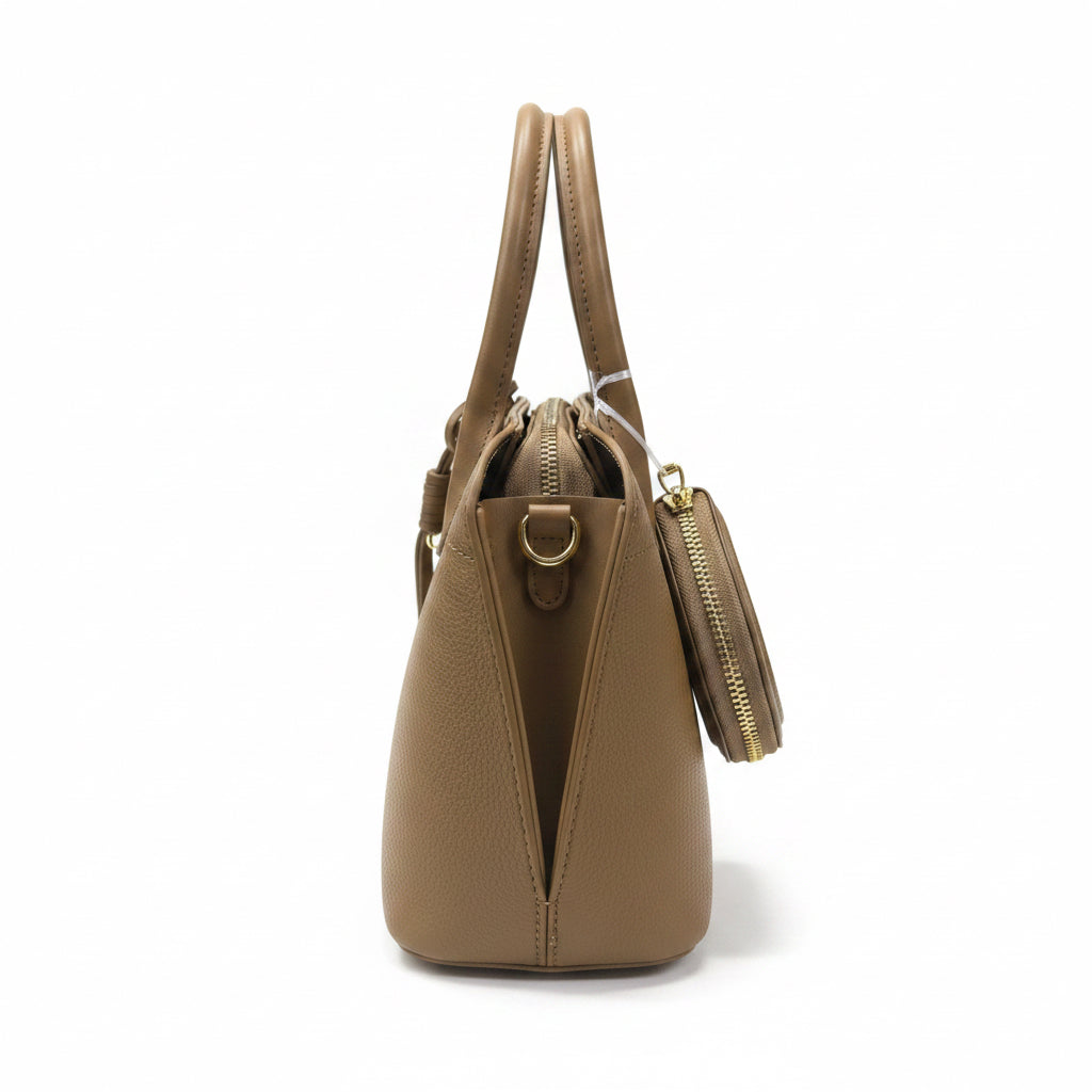 Side profile view of the textured beige handbag showing the expandable gusset and shoulder strap D-ring